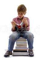 front view of boy sitting on books