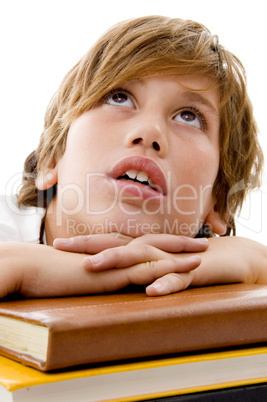 close view of boy with books and looking up