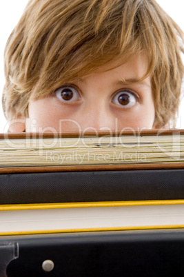 eyelevel view of boy with books