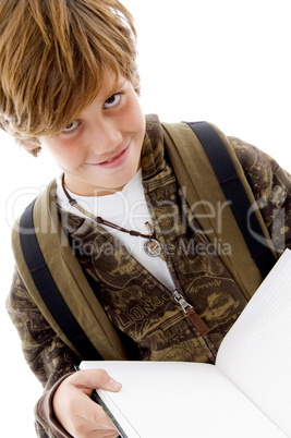 front view of smiling schoolchild reading