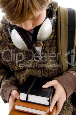 front view of boy with books and headphone