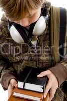 front view of boy with books and headphone