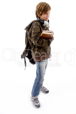 side pose of schoolboy with books and bag