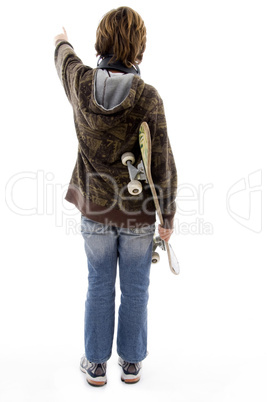 back pose of pointing boy holding skate