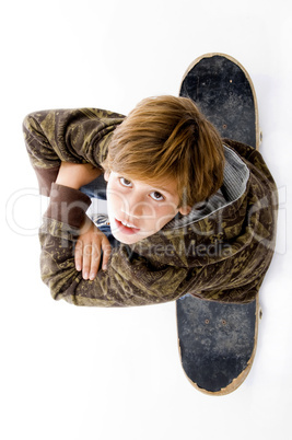 top view of boy sitting on skate