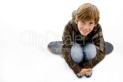 high angle view of boy sitting on skate