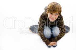 high angle view of boy sitting on skate