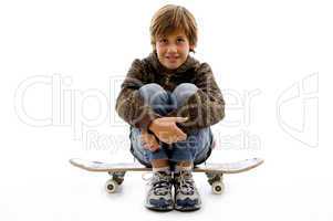 front view of boy sitting on skate