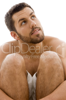 front view of man in towel looking sideways