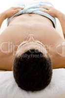 front view of man lying down for spa treatment