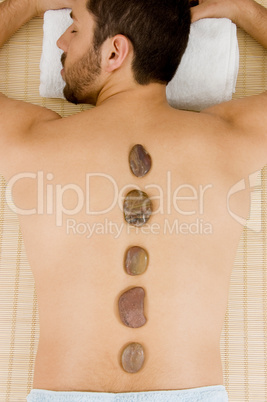 high angle view of man receiving hot stone massage