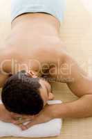 high angle view of man lying down for spa treatment