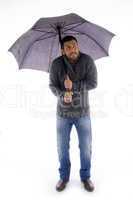 front view of man holding an umbrella and looking up