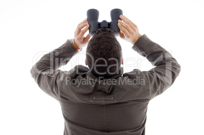 back pose of man using a pair of binoculars