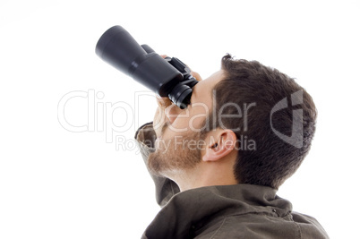 side view of hispanic man looking through binoculars