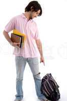 standing student pointing to bag
