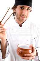 young chef with chopsticks and bowl