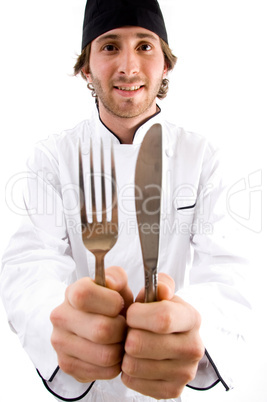 smiling chef showing knife and fork