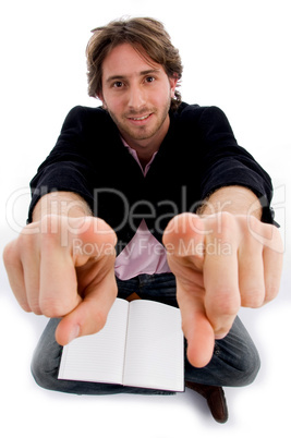 sitting pointing male with books