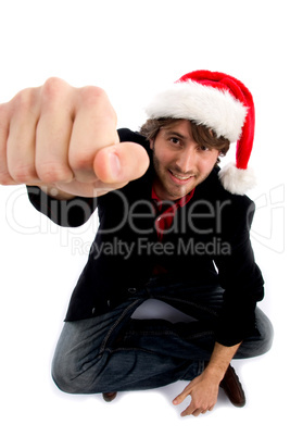 sitting male with christmas hat and showing punch