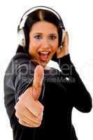 woman listening music and showing thumbs up