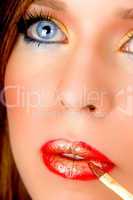 close up of model putting lipstick