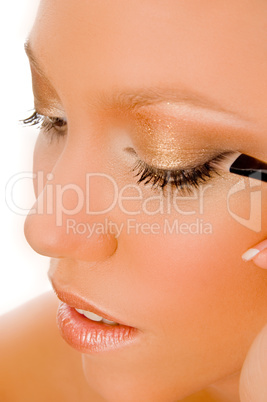 close up of young woman getting makeup