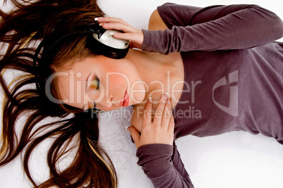 top view of laying female enjoying music