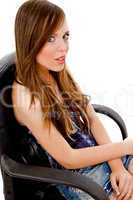 side view of young model sitting on chair