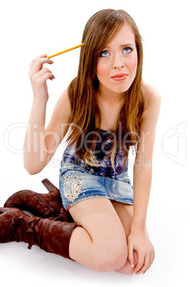 top view of thinking student holding pencil