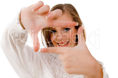 close view of smiling woman showing framing hand gesture