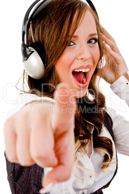 sidepose of female holding headphone and pointing