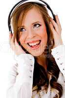 front view of smiling female listening music