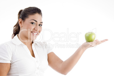 pretty young caucasian posing with an apple on her palm