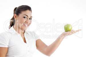 pretty young caucasian posing with an apple on her palm