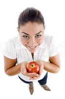 high angle view of beautiful young female holding an apple