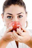 young attractive model holding an apple near to her nose