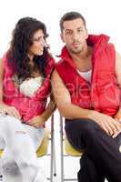 young amorous couple resting on chair