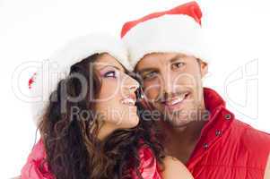 cheerful young couple wearing christmas hat