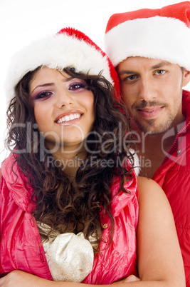 young amorous couple wearing christmas hat