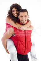 young male carrying woman piggyback