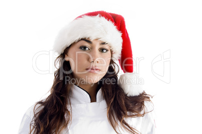 young chef wearing christmas hat and looking at camera