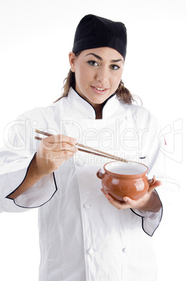 beautiful female chef posing with chopstick and bowl