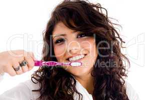 young pretty female holding toothbrush