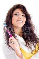 young pretty female holding toothbrush