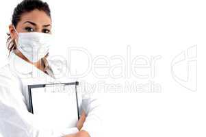 doctor with mask on her mouth and writing board