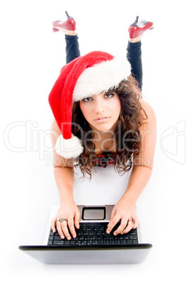 laying female with christmas hat and laptop