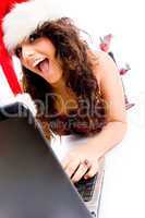 woman wearing christmas hat and working on laptop