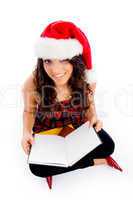 female with christmas hat and blank book