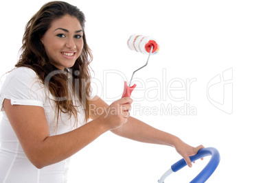 young girl holding rolling brush